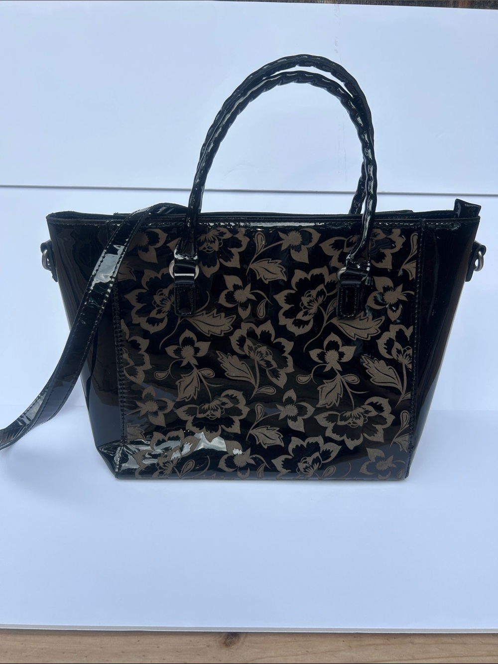 Patricia Nash Tooled Adeline Tote in a black patent finish with a floral pattern